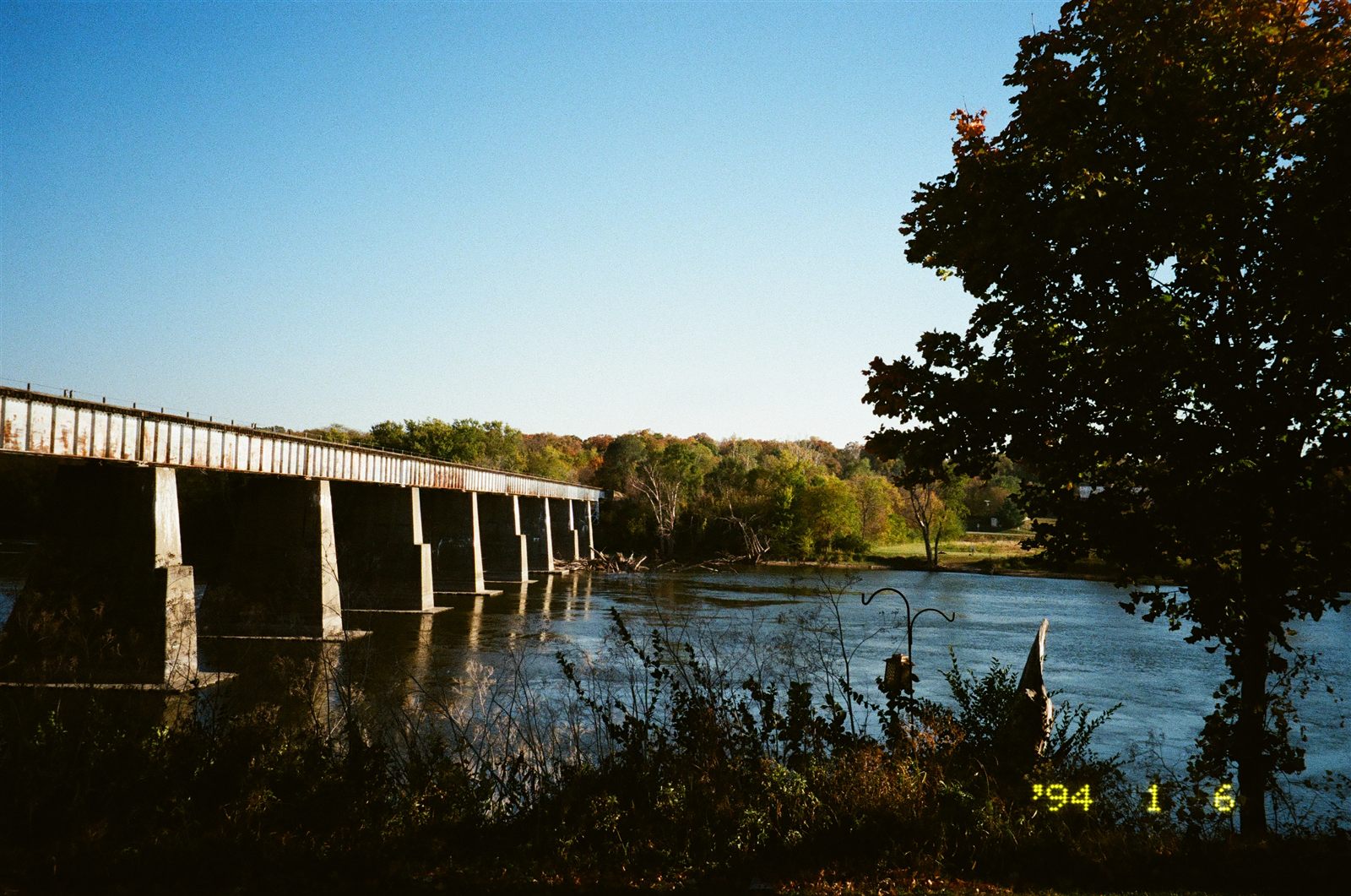 Railroad bridge from the bank — original scan